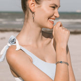 model wearing astral lunar curb link bracelet in natural light, wrist close-up